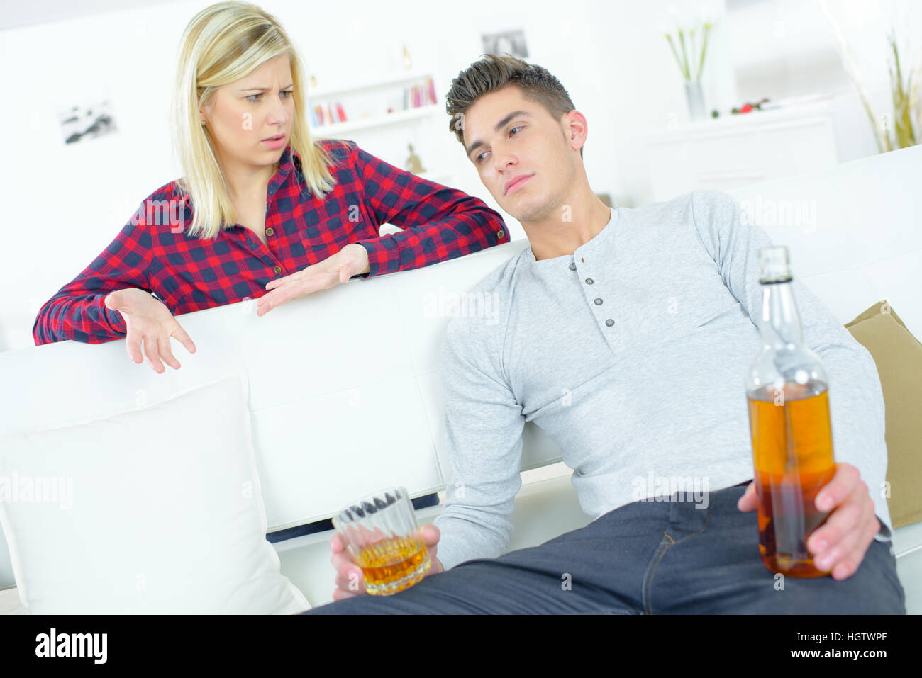 teenager drinking on couch Stock Photo