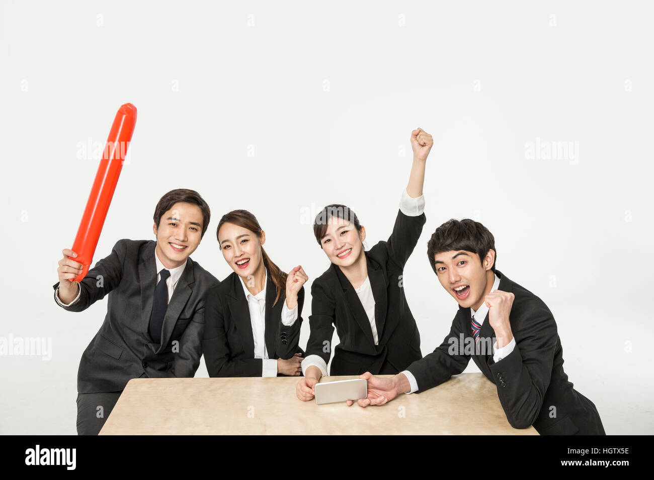 Young smiling Korean business people cheering Stock Photo