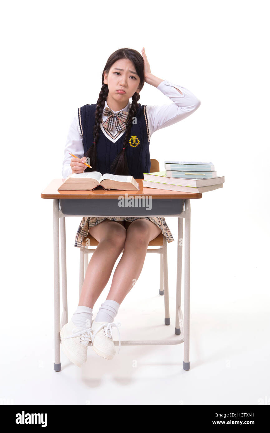 High school girl embarrassed sitting at desk Stock Photo - Alamy