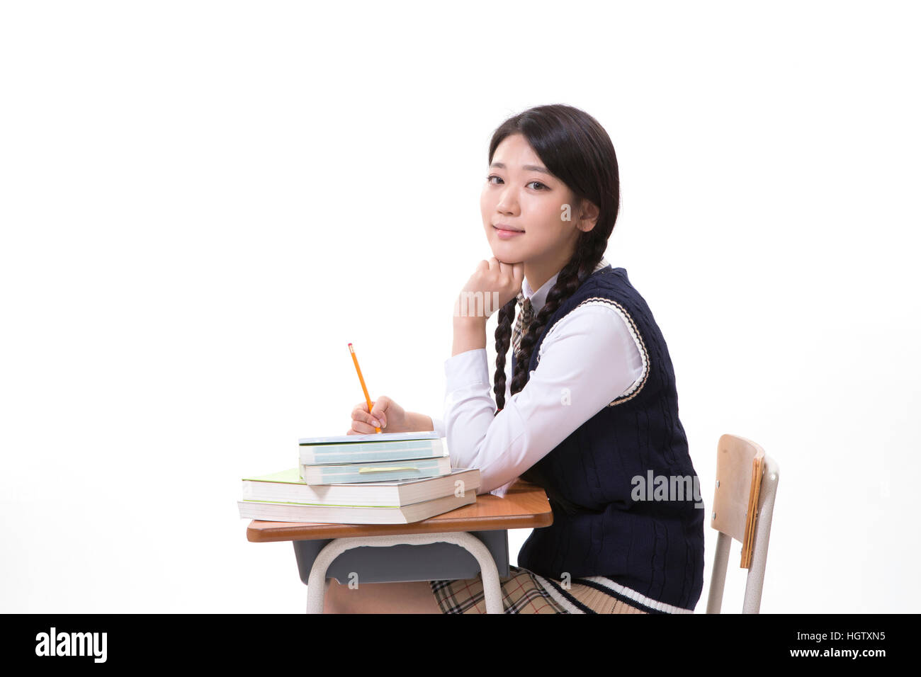 Side view of high school girl sitting at desk Stock Photo - Alamy