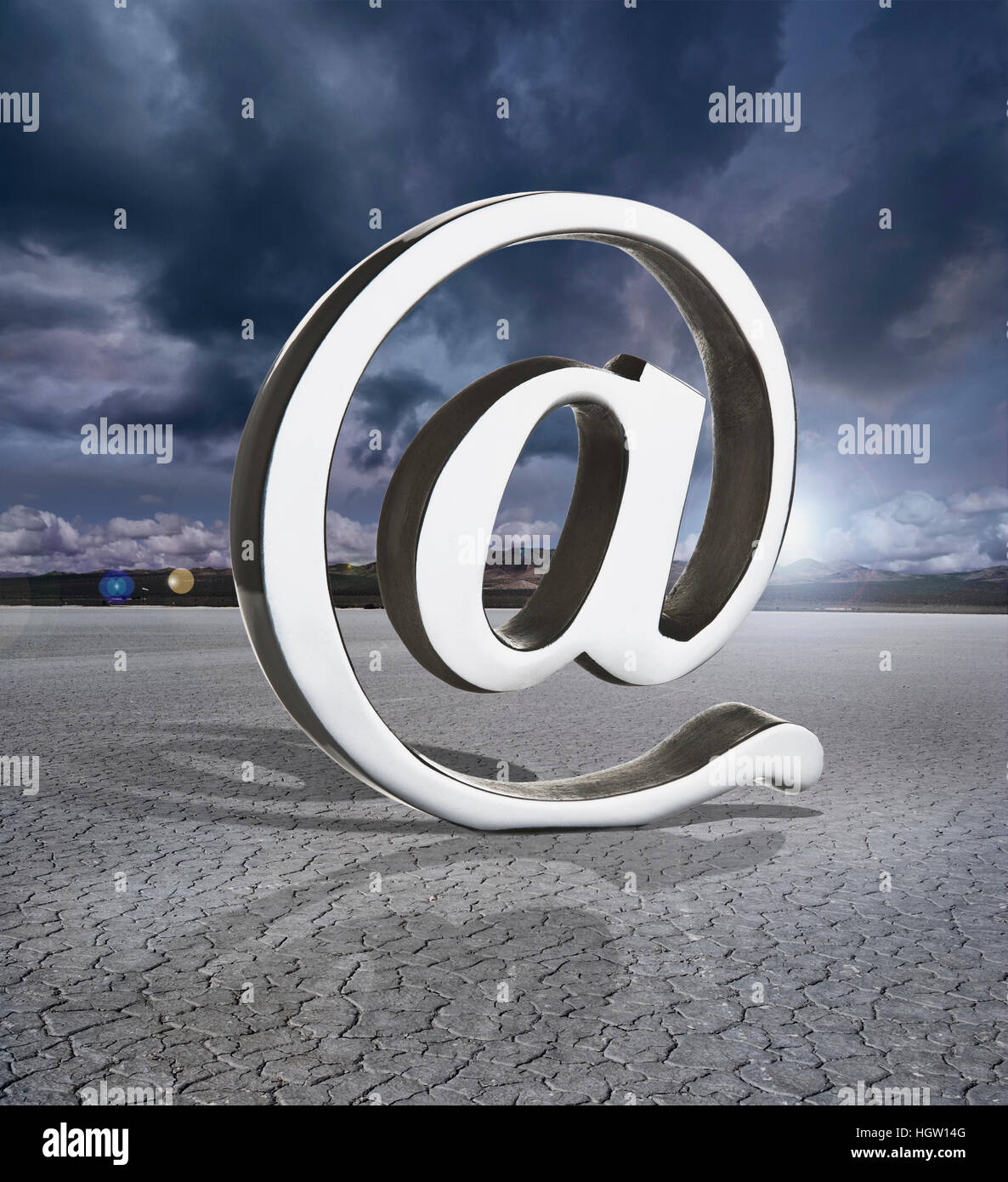 At Symbol In A Dry Lake Bed With Storm Clouds Stock Photo