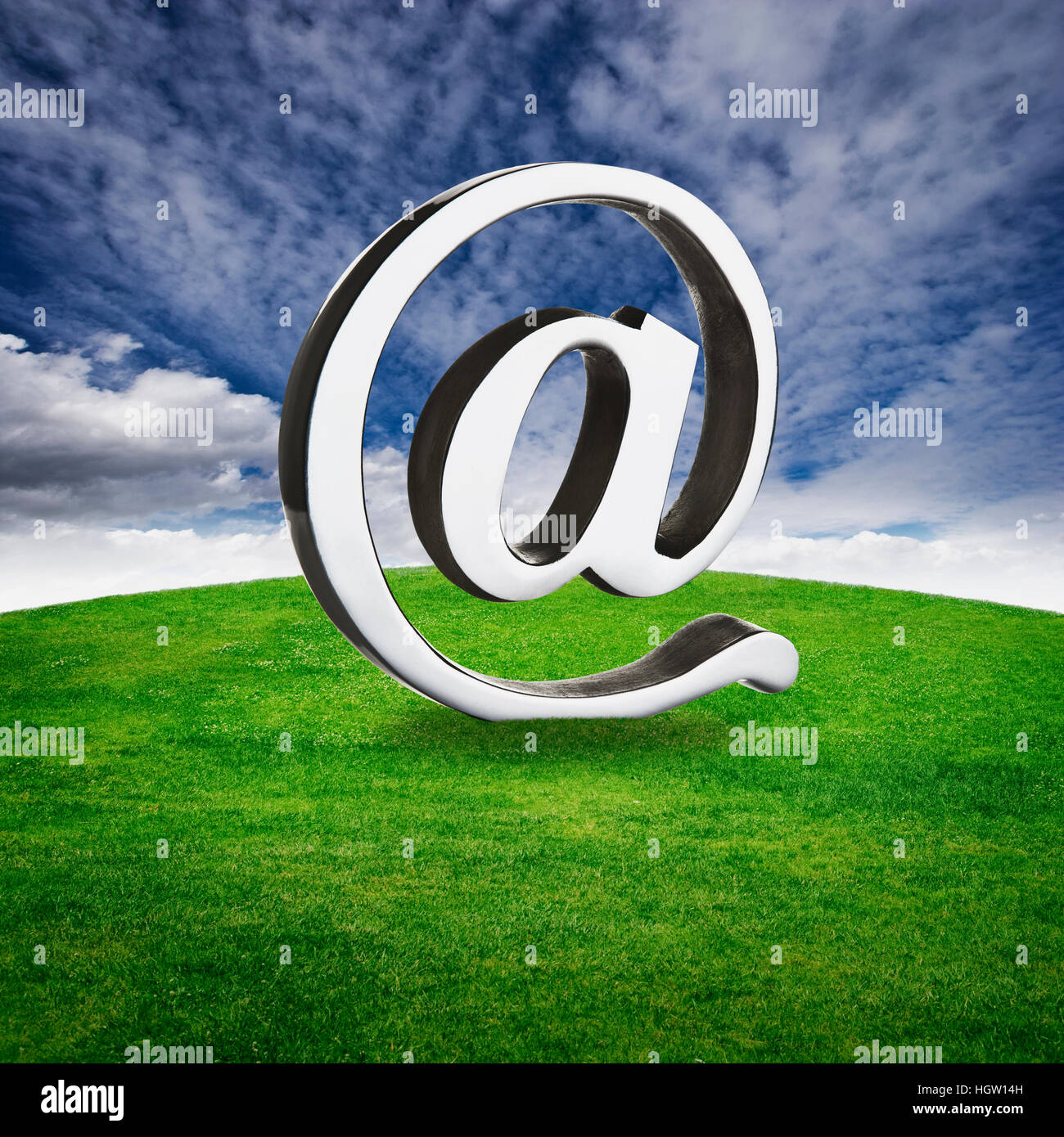 At Symbol On A Grassy Hill Stock Photo