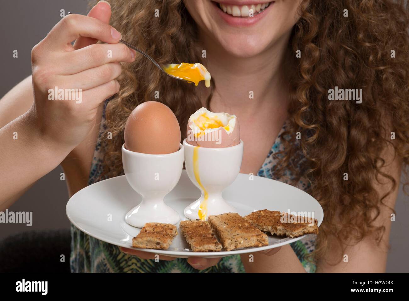 Young girl eating boiled eggs for breakfast Stock Photo Alamy
