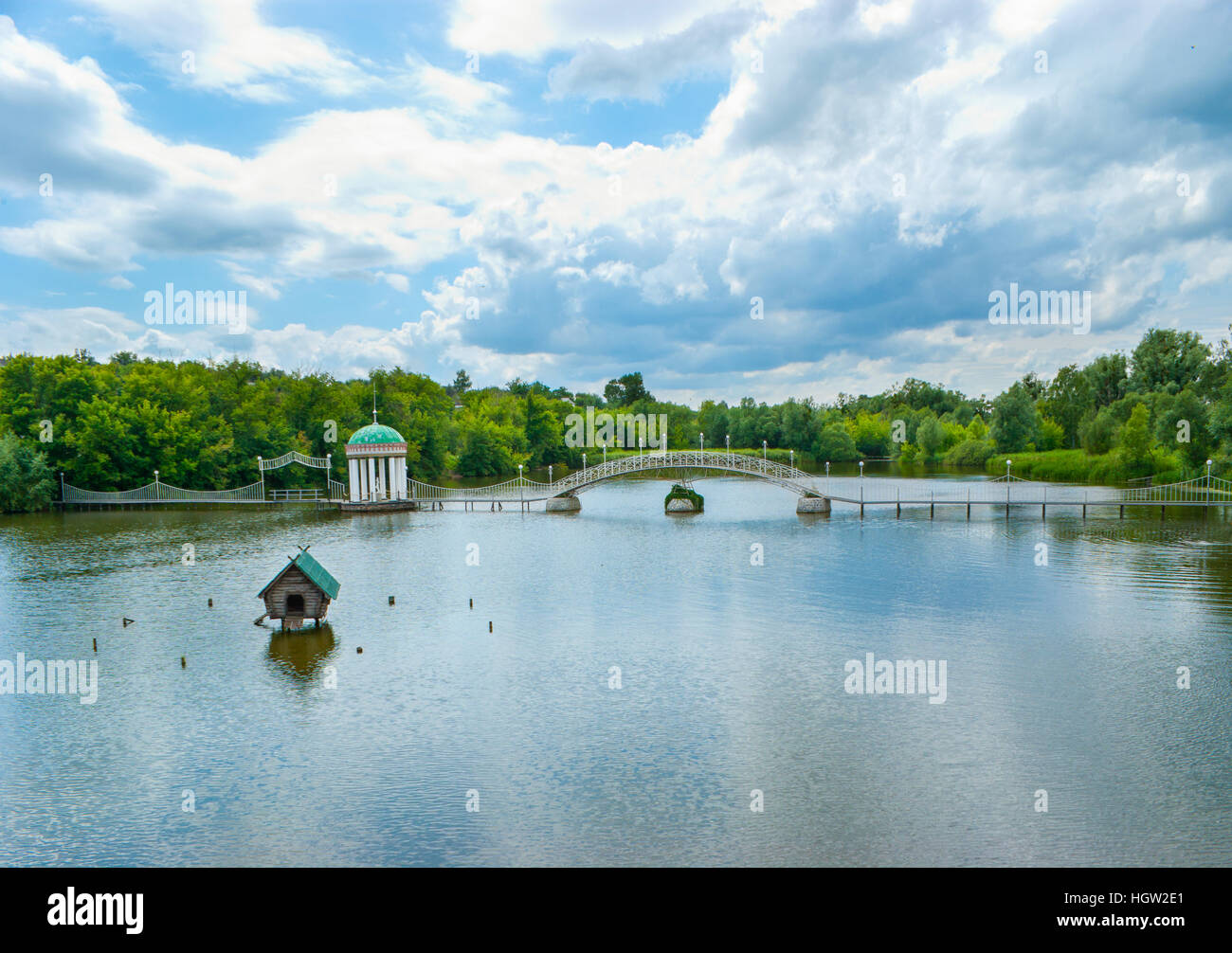 The bridge with arbor and small house for swans on the pond Stock Photo ...
