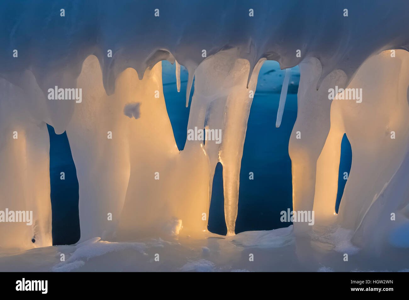 Thick ice formed from waves splashing on handrail near Grand Haven