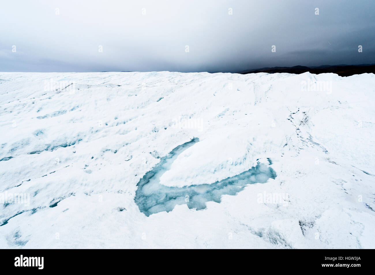 A melt pond on the surface of the Greenland Ice Shelf. Stock Photo