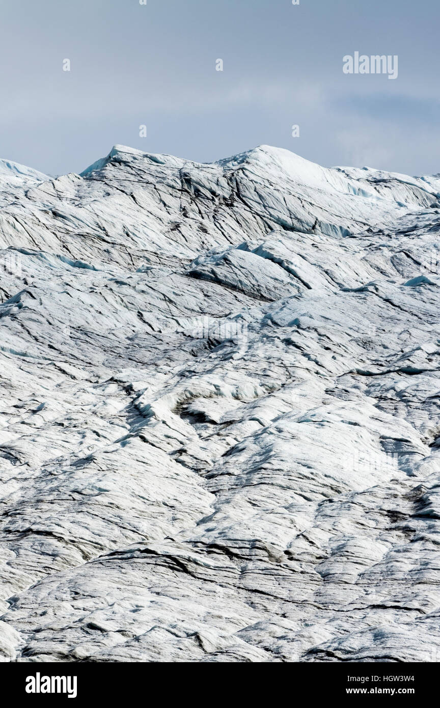 A lunar landscape of tortured layers of ice on the surface of a glacier. Stock Photo