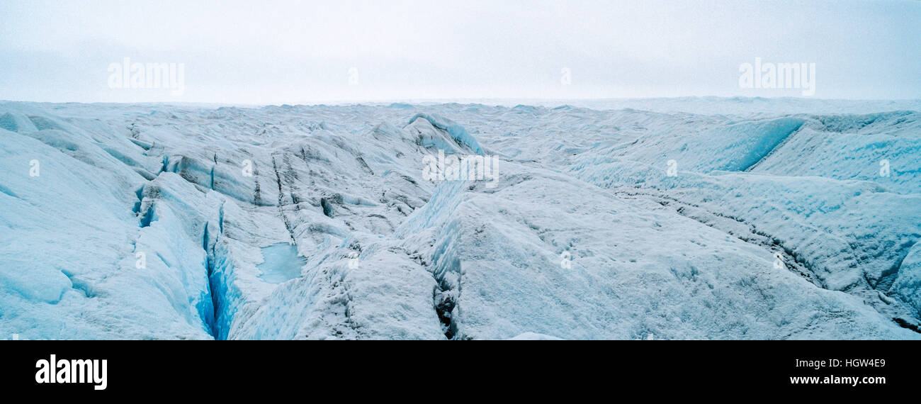 The frozen and barren wasteland of ice and crevasse on the surface of the Greenland Ice Sheet. Stock Photo