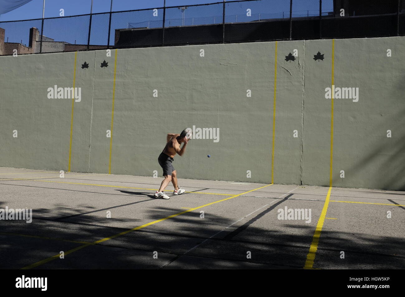 NEW YORK, NY:  A man plays hand ball at one of the many courts in downtown Manhattan. Stock Photo