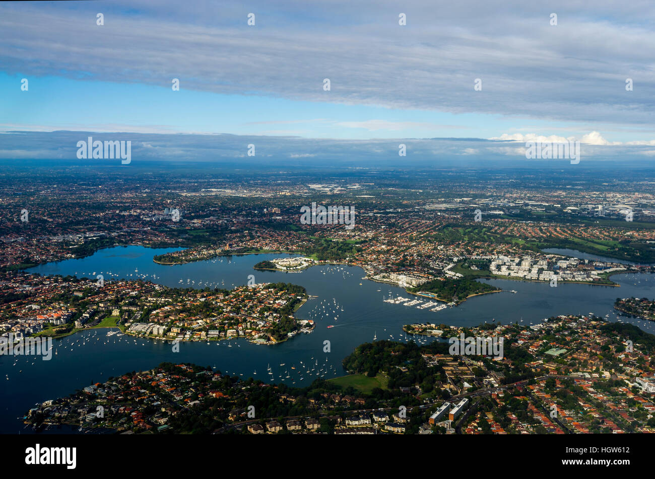 The rooftops of sprawling suburbs surrounding a harbour bay near Sydney. Stock Photo