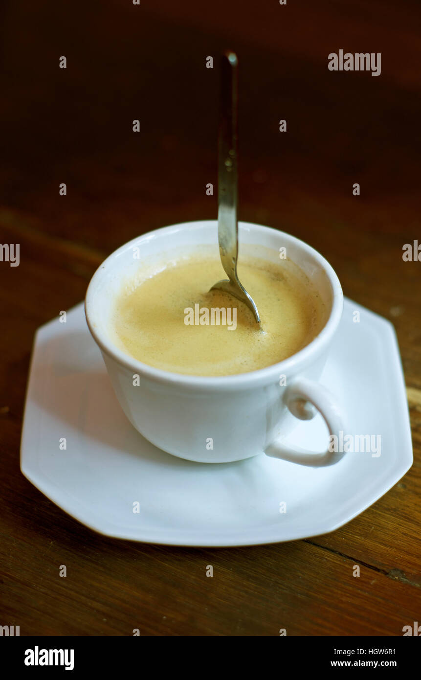 Very strong cup of coffee with spoon standing up in it Stock Photo Alamy