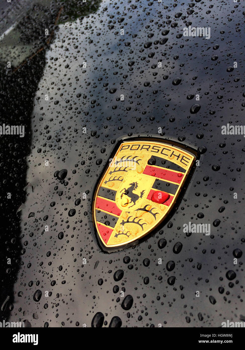 Porsche coat of arms in car front, raindrops Stock Photo