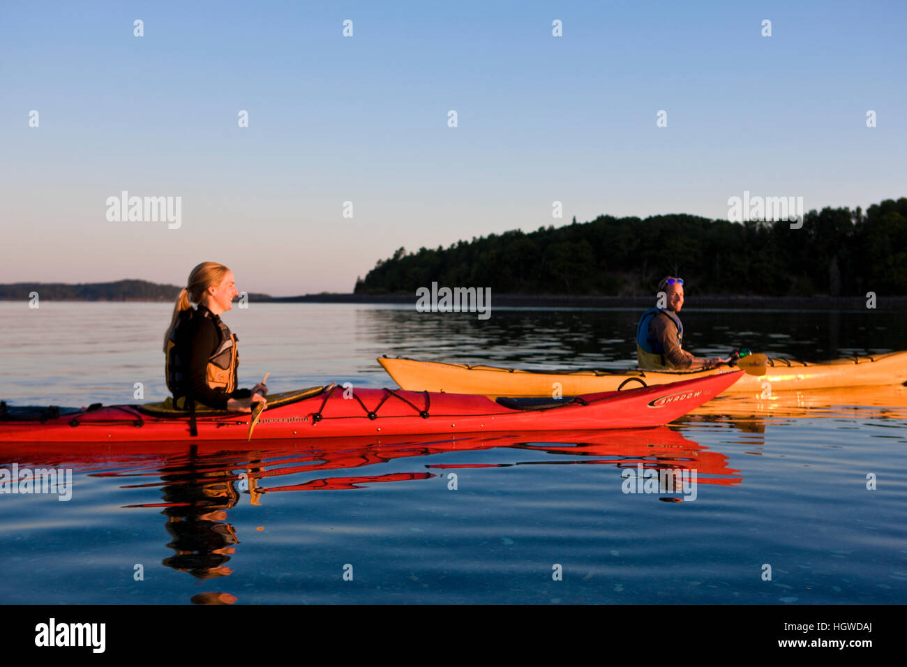 A man and woman sea kayaking near Sheep Porcupine Island in Maine's