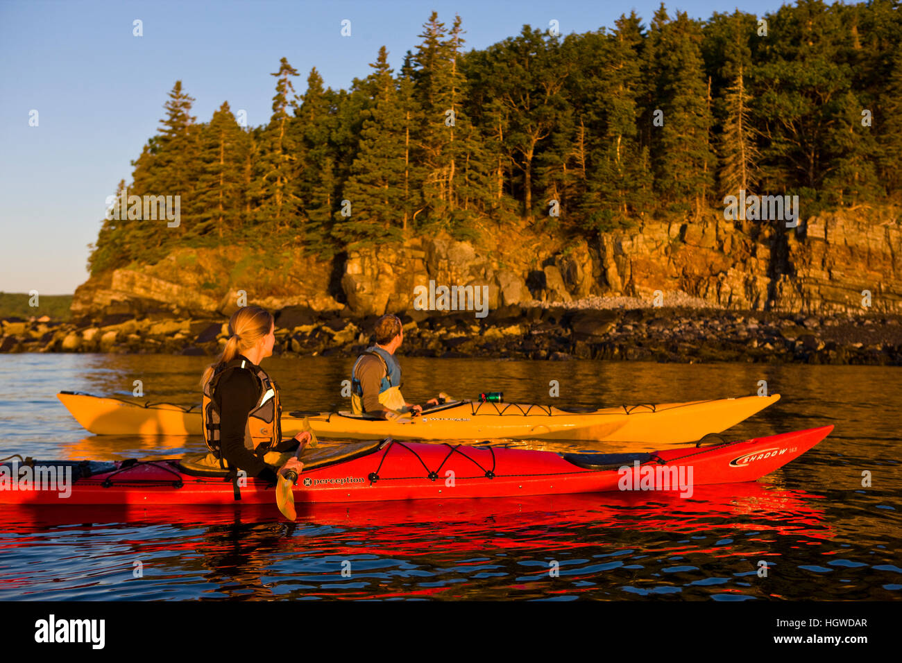 A man and woman sea kayaking near Sheep Porcupine Island in Maine's
