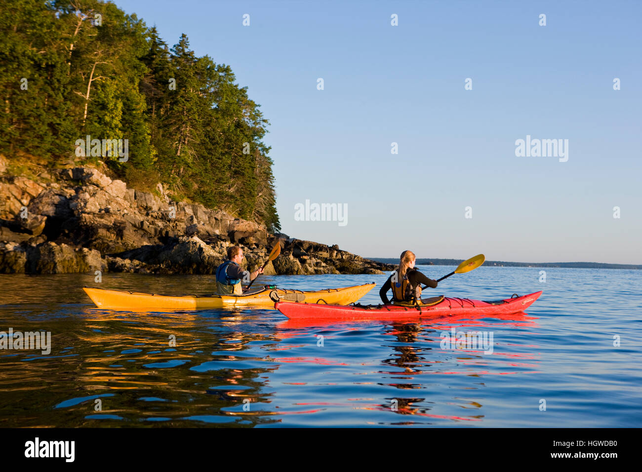 A man and woman sea kayaking near Sheep Porcupine Island in Maine's