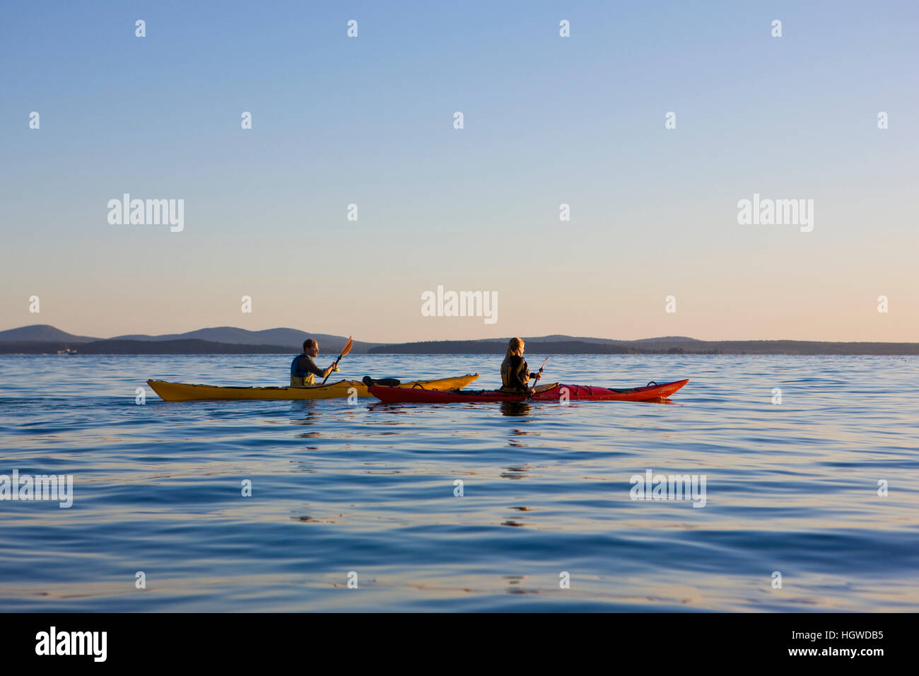 A man and woman sea kayaking near Sheep Porcupine Island in Maine's