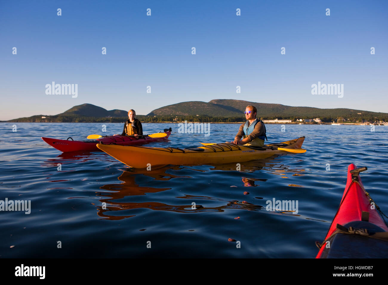 A man and woman sea kayaking near Burnt Porcupine Island in Maine's
