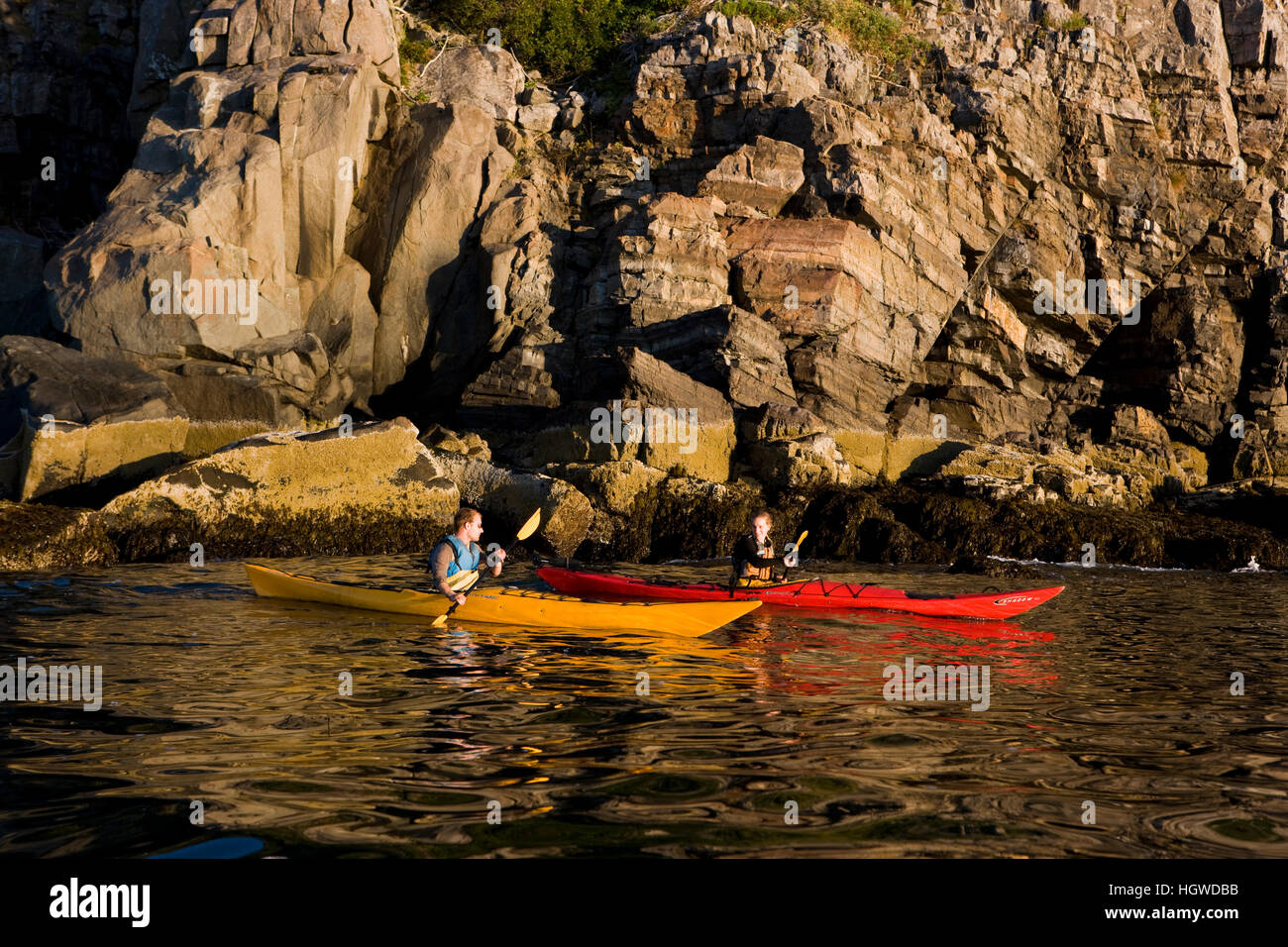 A man and woman sea kayaking near Burnt Porcupine Island in Maine's