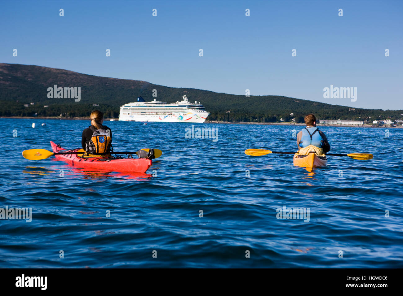 A young couple sea kayaking near the Porcupine Islands in Maine's