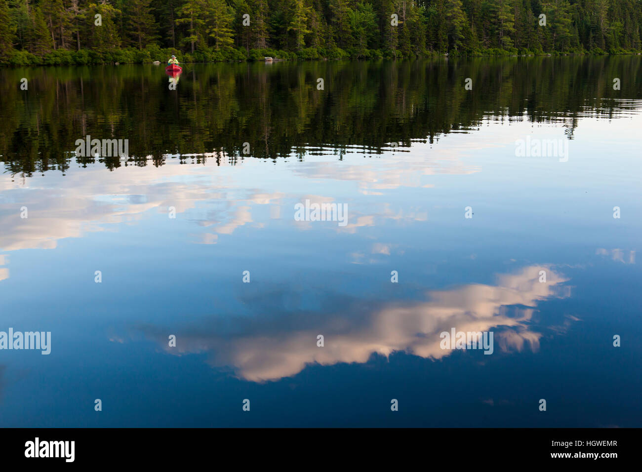 Two men flyfishing for brook trout from a canoe on Lang Pond in Maine