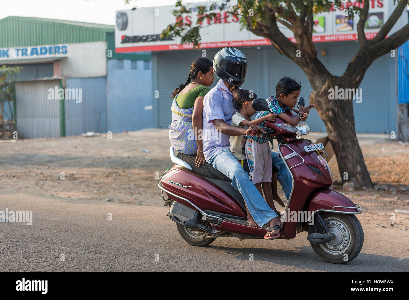 Man with his wife and two children riding on a motor scooter Stock Photo