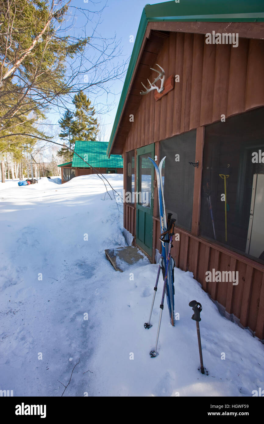 Skis In The Snow Outside A Cabin At Medawisla Wilderness Camps