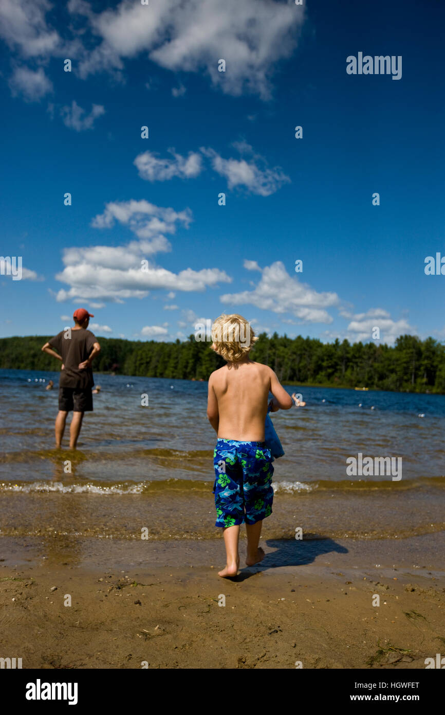 A boy plays on the beach at Otter Lake in Greenfield State Park in Greenfield, New Hampshire