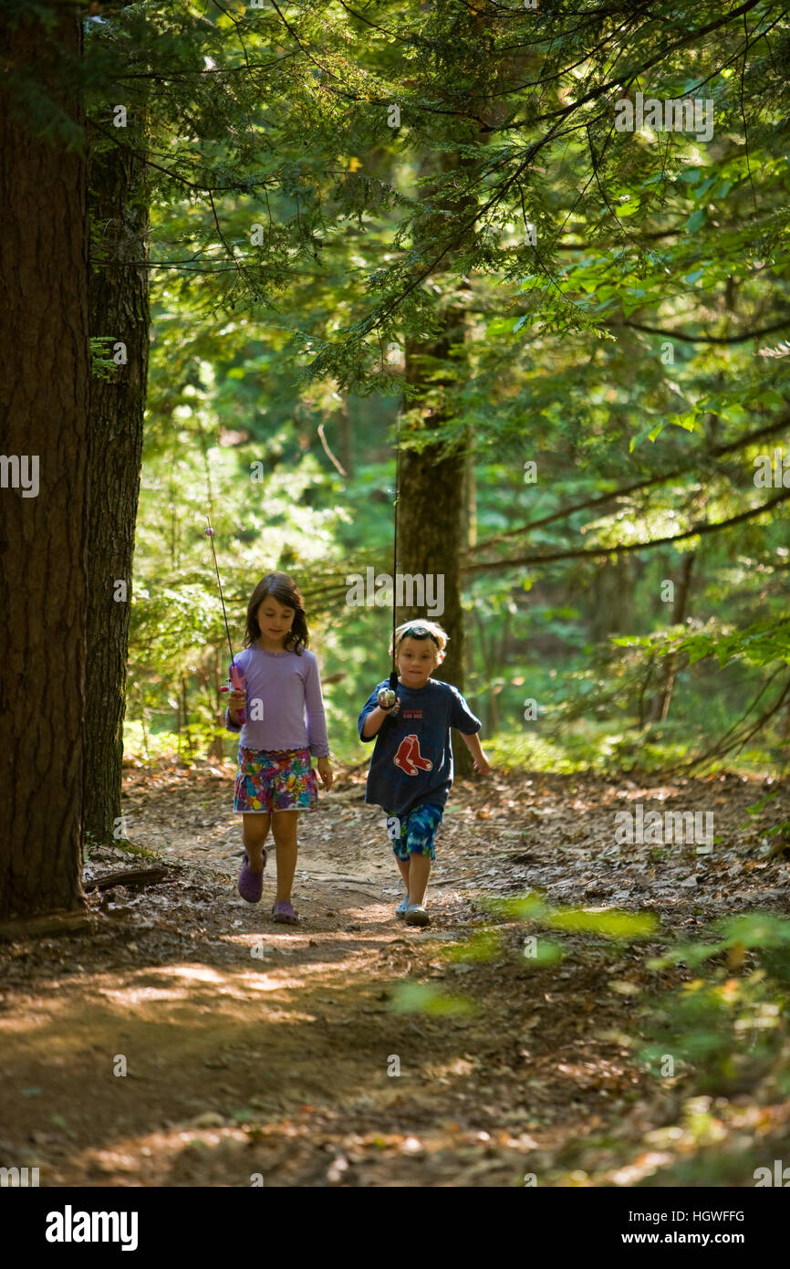 Kids walk with their fishing poles in Greenfield State Park in