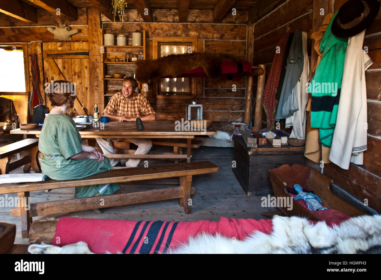 Fort Edmonton, Alberta, Canada, interior of married men's quarters with docent and visitor Stock Photo