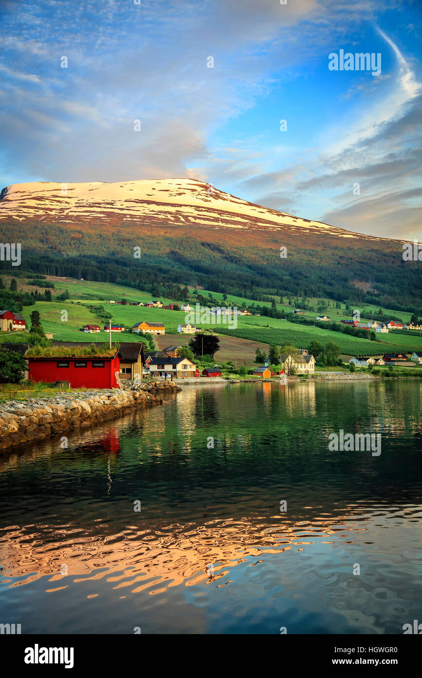 Dusk light hitting the mountains behind Innvik in Norway creating beautiful reflections. Stock Photo