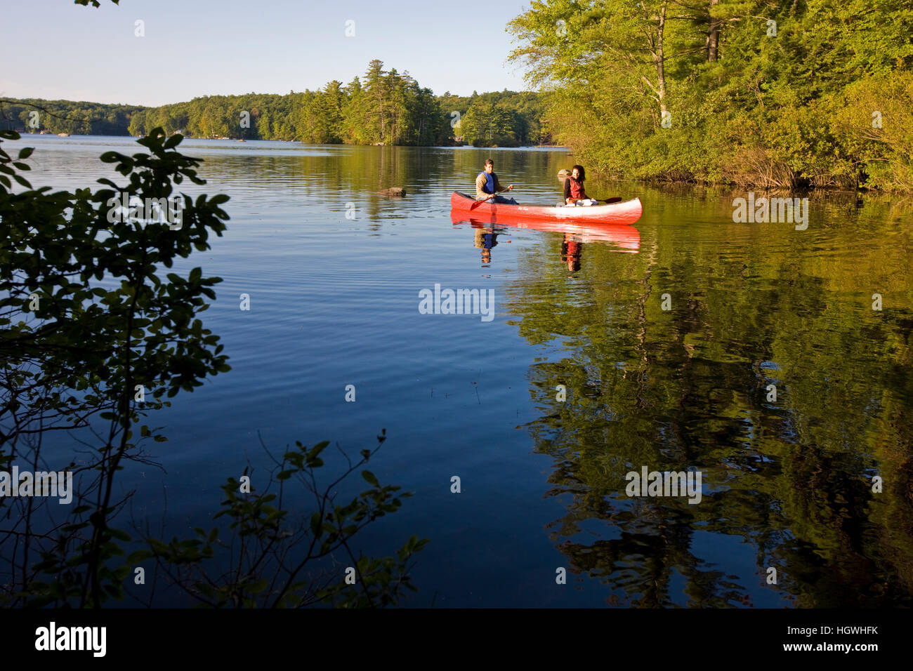 A couple canoeing on Pawtuckaway Lake in New Hampshire's Pawtuckaway