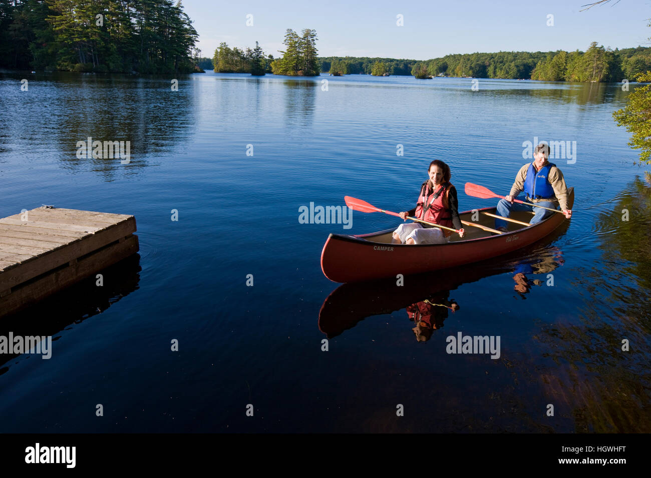 A couple canoeing on Pawtuckaway Lake in New Hampshire's Pawtuckaway