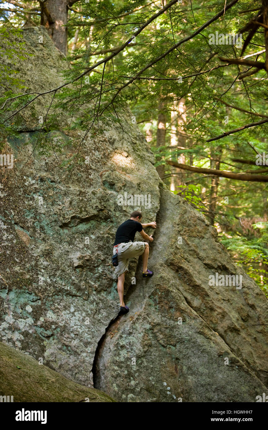 A man bouldering in "The Boulders" section of New Hampshire's