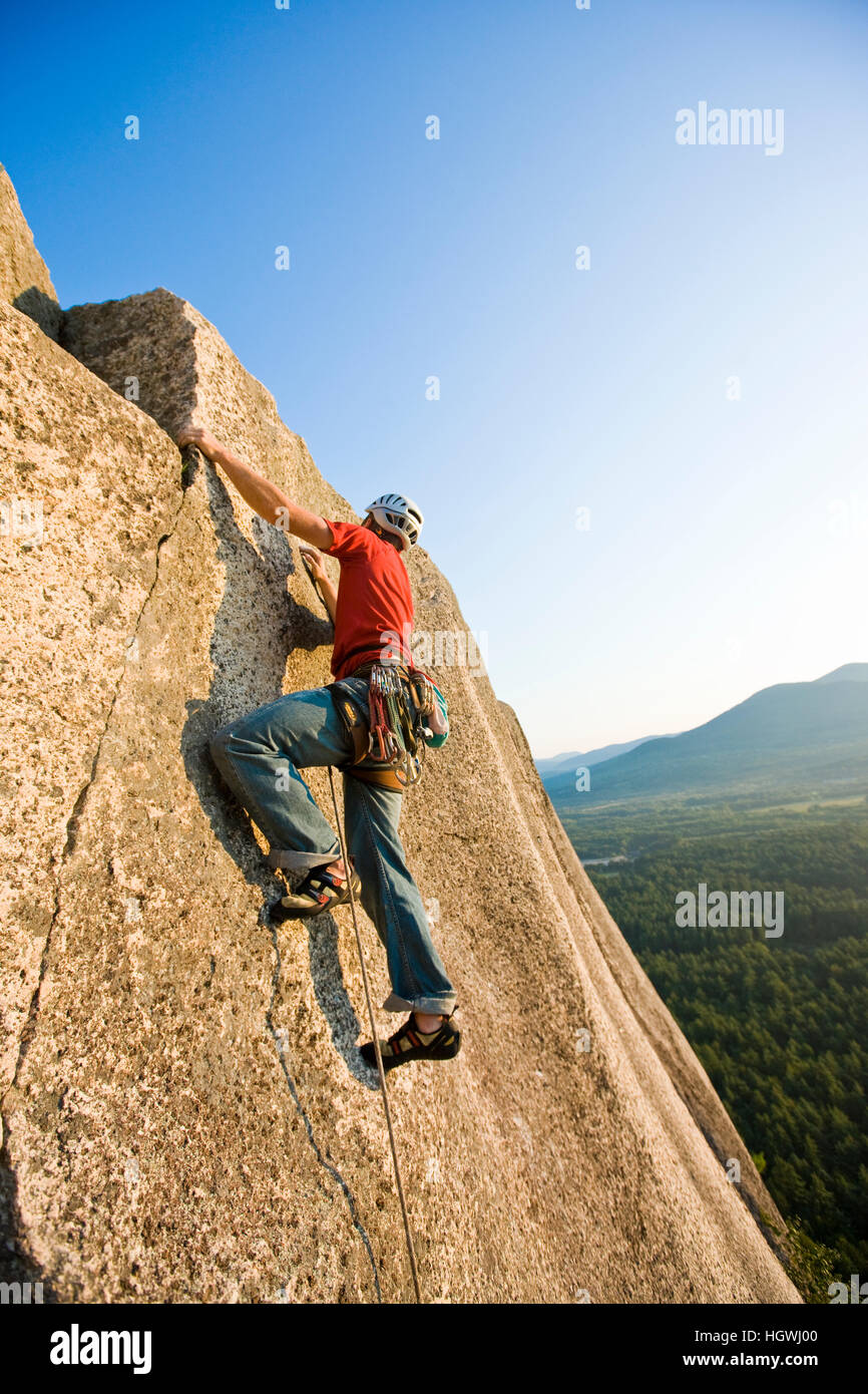 A man rock climbing near the top of Cathedral Ledge. Echo Lake State