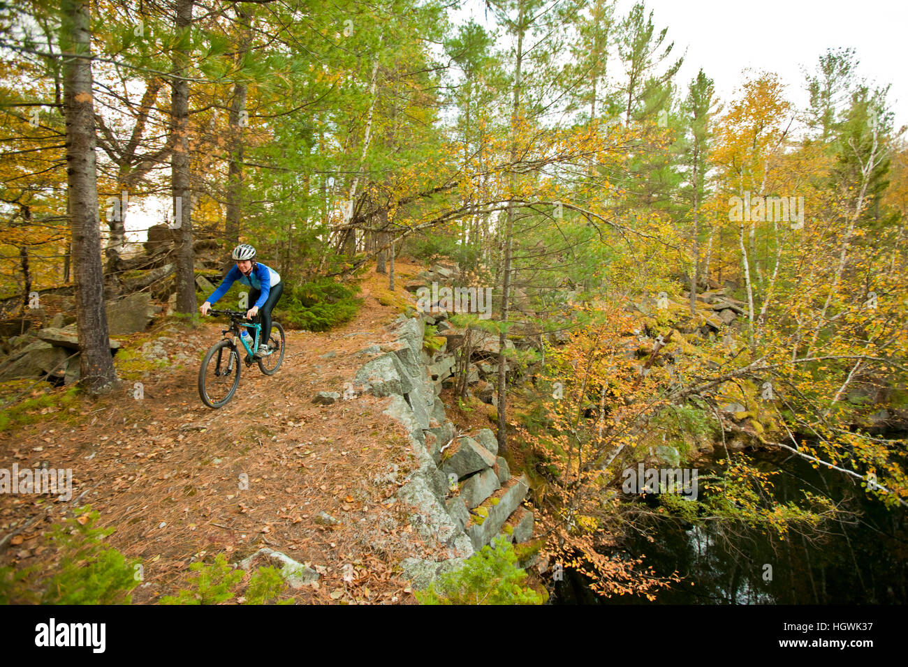 A woman mountain biking on a trail on Millstone Hill in Barre, Vermont