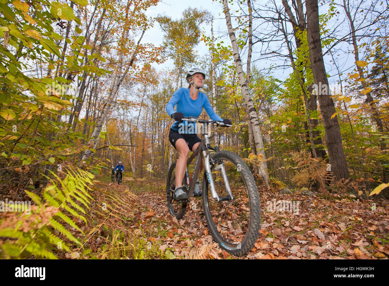 Women mountain biking on a trail on Millstone Hill in Barre, Vermont