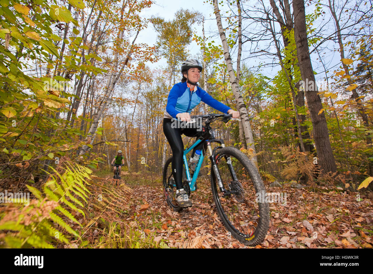 Women mountain biking on a trail on Millstone Hill in Barre, Vermont