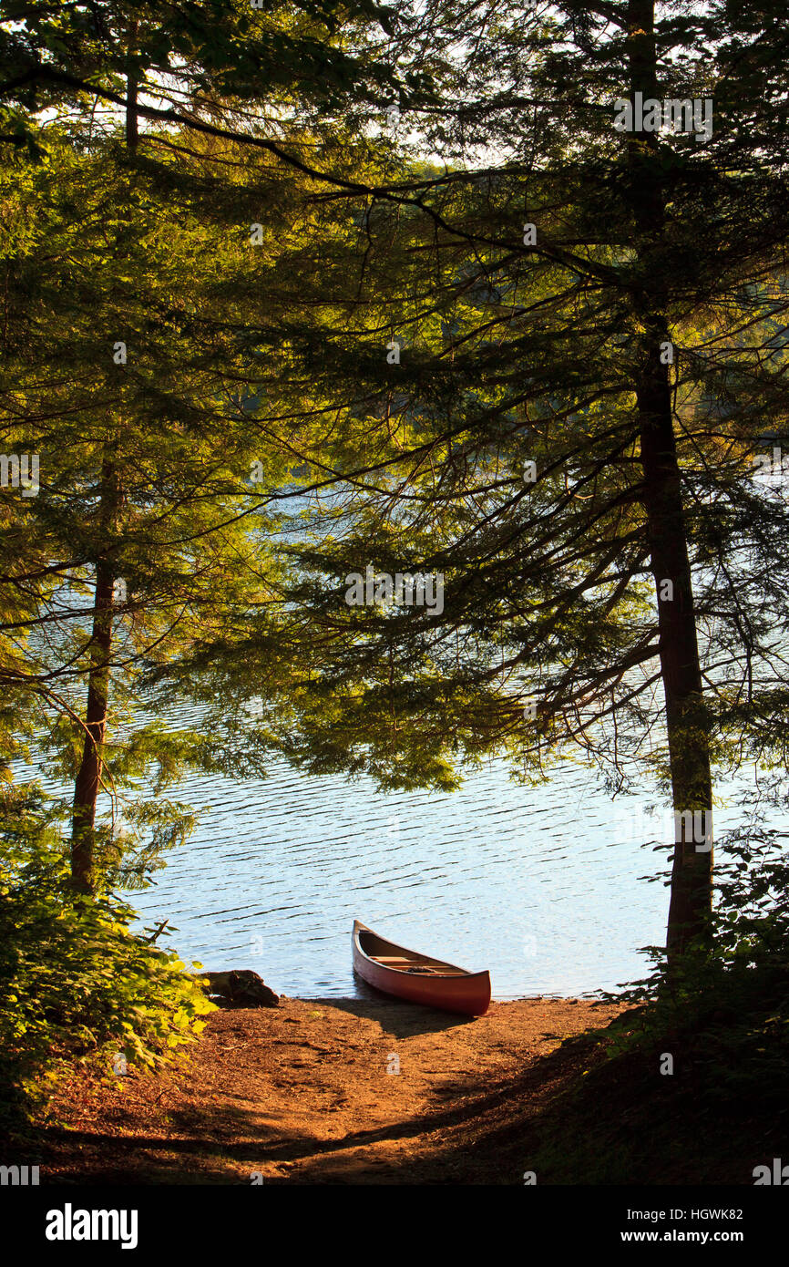 Canoe on the shore next to Zack Woods Pond in Hyde Park, Vermont. Stock Photo