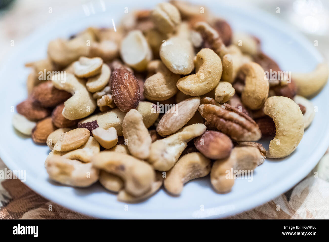 Macro closeup of salted mixed nuts in plate Stock Photo Alamy