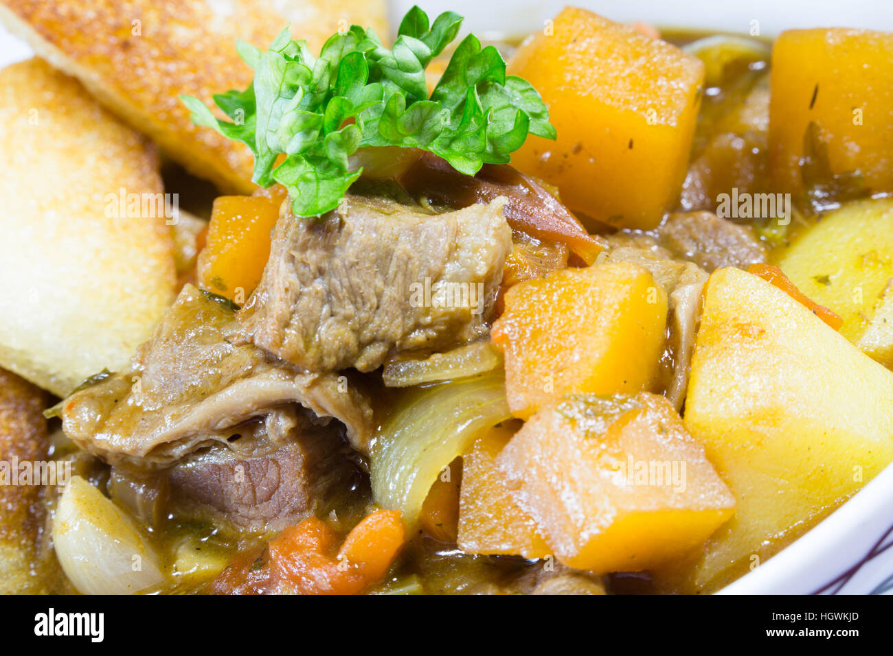 An English pub/restaurant bowl of Beef Casserole served with fried bread croutons. Stock Photo
