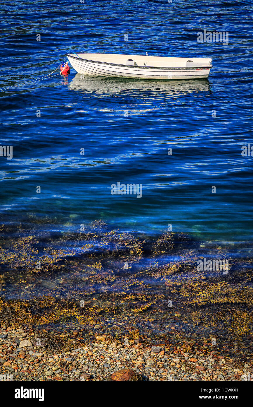 A boat reflected in the cold waters of the Nordfjorden at Tistam in Norway. Stock Photo