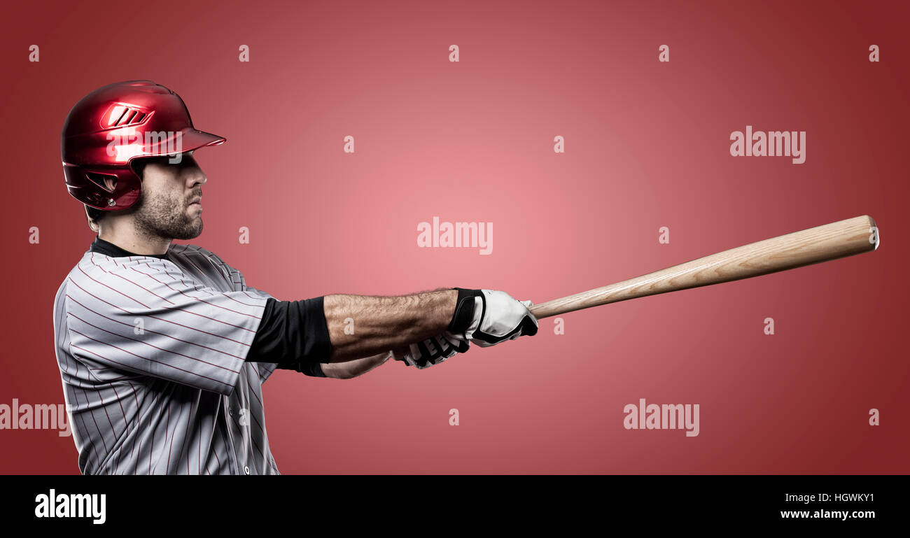 Baseball Player on a Red Uniform on red background Stock Photo - Alamy
