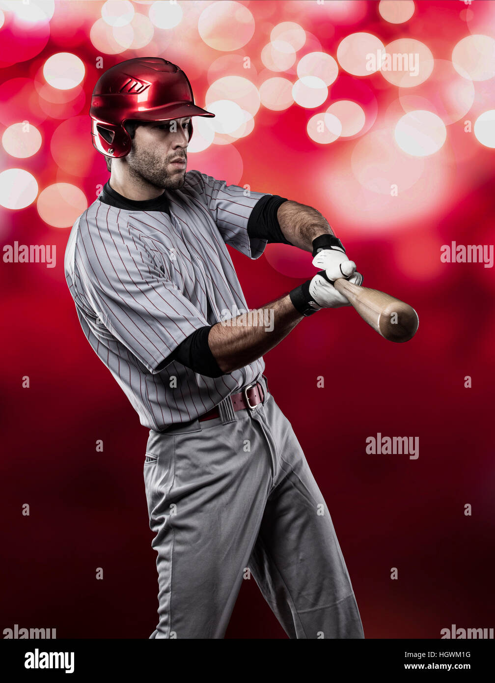 Baseball Player on a Red Uniform on red lights background Stock Photo ...