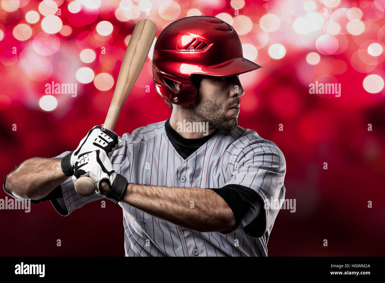 Baseball Player on a Red Uniform on red lights background Stock Photo ...