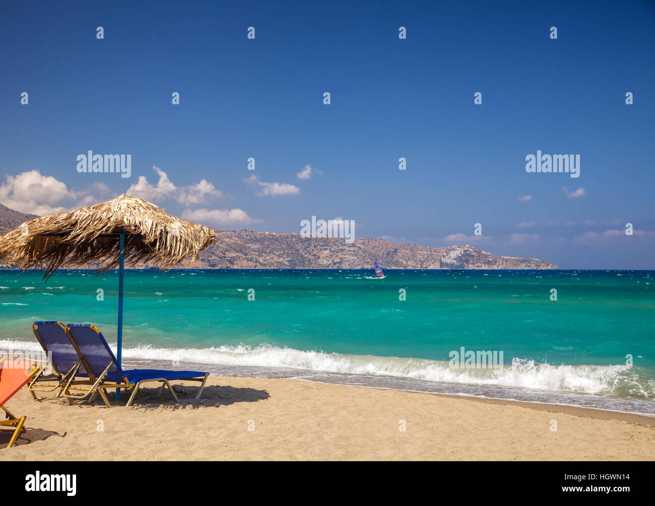 Blue sun loungers with parasol on a beach near Heraklion, Crete Stock Photo
