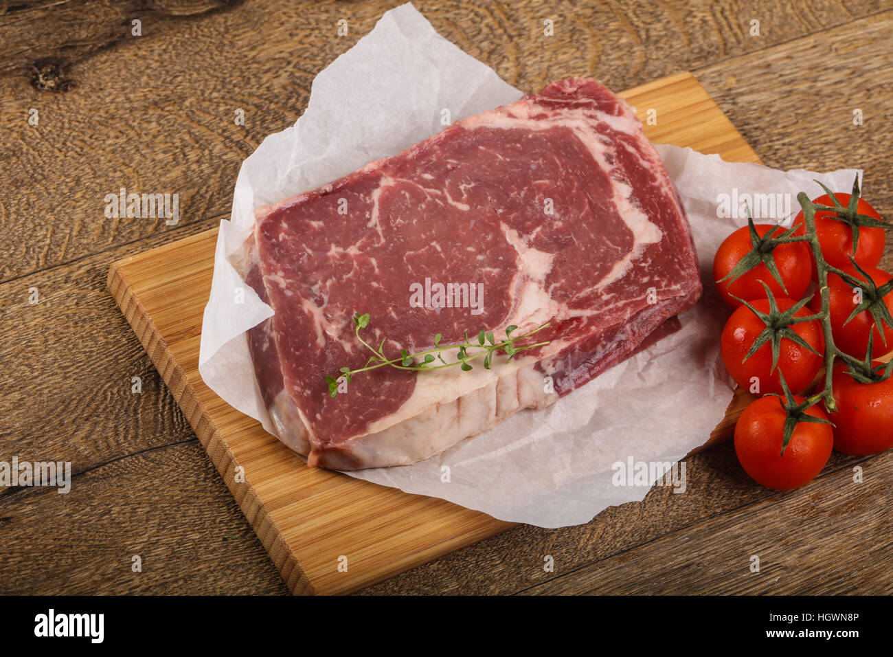 Raw ribeye steak with thyme - ready for cooking Stock Photo - Alamy