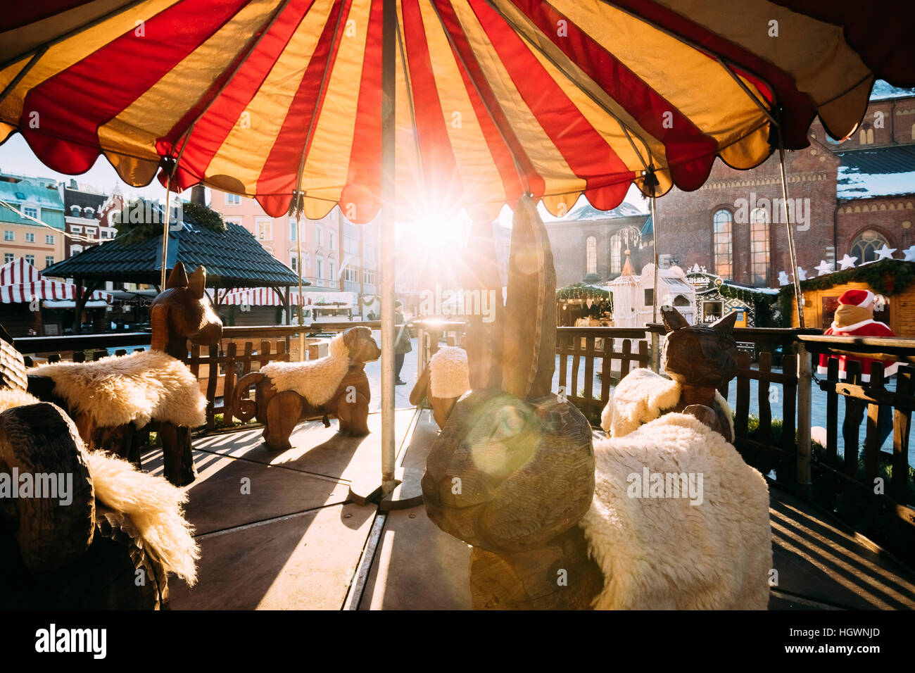 Traditional Vintage Old Carousel Merry-go-round On Christmas Market On The Dome Square In Riga, Latvia. Winter Holidays, New Year In Europe. Sun Is Sh Stock Photo
