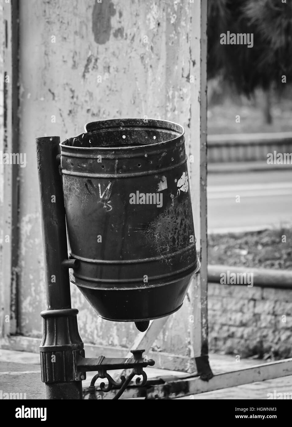 Metal trash can on the street in black and white colors Stock Photo