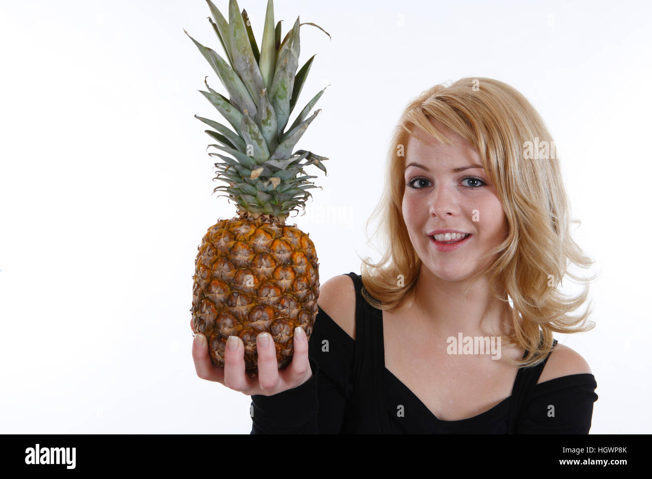 Woman with a pineapple in her hand Stock Photo Alamy