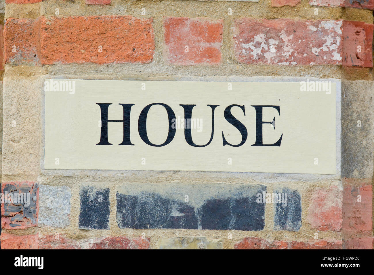 House sign painted on brick as part of wall Stock Photo